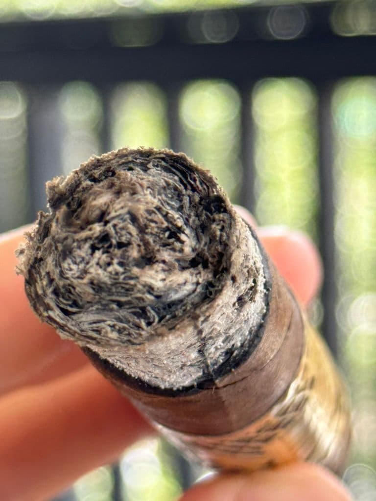 Macro of Création Liberté ash and wrapper near the burn line